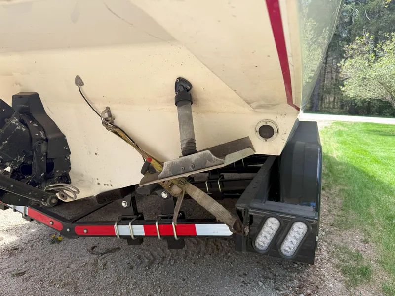 Slide: The Image of 1988 Slickcraft 268 SC boat stern with trailer, showing anchor and propeller details. - 12