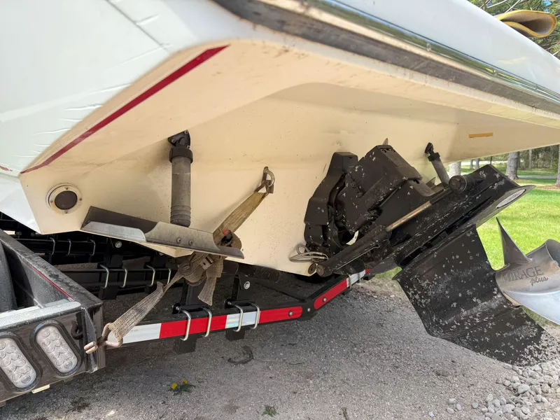 Slide: The Image of 1988 Slickcraft 268 SC boat stern with trailer, showing propeller and trim tabs. - 13