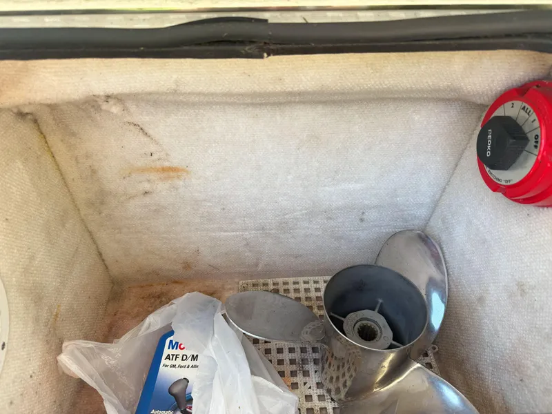 Slide: The Image of Storage compartment of 1988 Slickcraft 268 SC boat with propeller and oil container. - 15