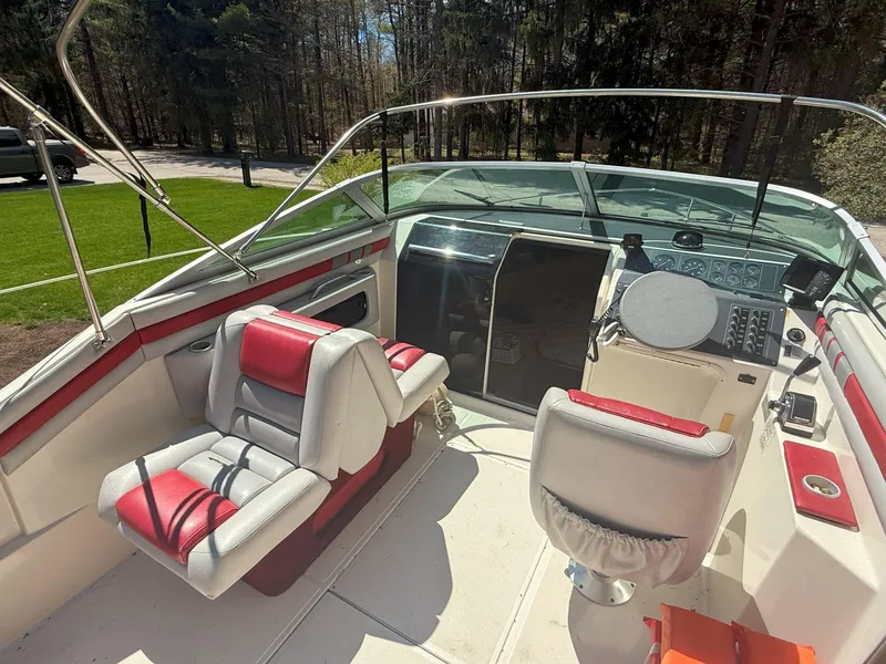 Slide: The Image of 1988 Slickcraft 268 SC boat interior with red and white seating, steering console, and windshield. - 20