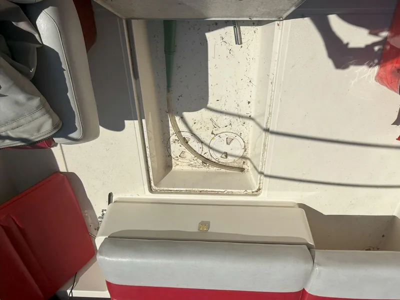 Slide: The Image of 1988 Slickcraft 268 SC boat interior with red and white seating, showing storage compartment. - 22