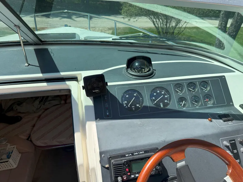 Slide: The Image of 1988 Slickcraft 268 SC boat dashboard with gauges and steering wheel. - 24