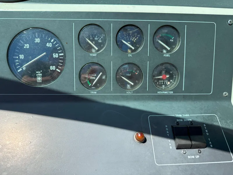 Slide: The Image of Dashboard of a 1988 Slickcraft 268 SC boat with various gauges and controls. - 26