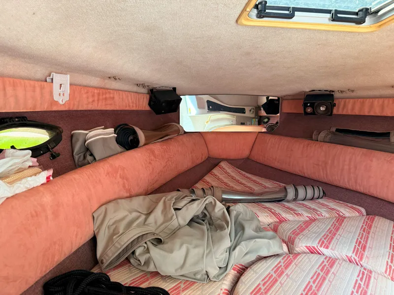 Slide: The Image of Interior cabin of a 1988 Slickcraft 268 SC boat with pink upholstery and storage items. - 28