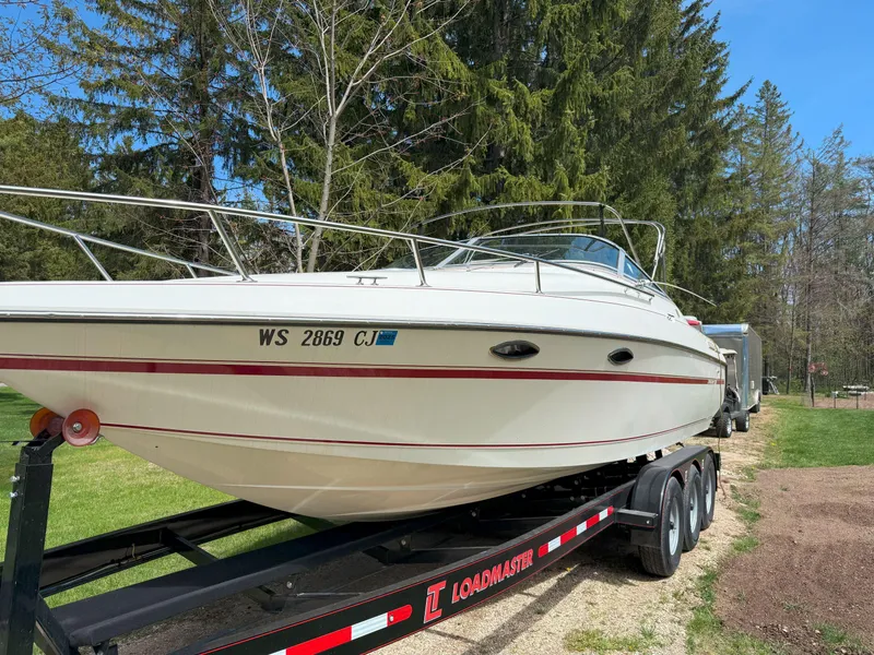 Slide: The Image of 1988 Slickcraft 268 SC boat on a Loadmaster trailer, parked outdoors. - 3