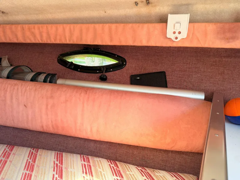 Slide: The Image of Interior cabin of 1988 Slickcraft 268 SC boat with porthole and storage. - 38