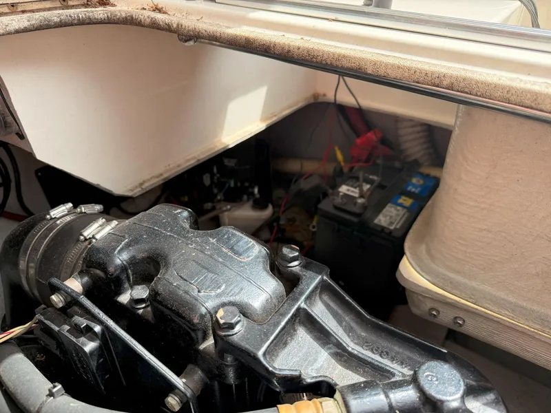 Slide: The Image of Engine compartment of a 1988 Slickcraft 268 SC boat, showing mechanical components and battery. - 41