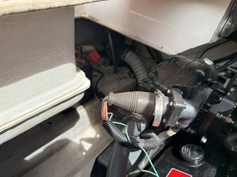 Slide: The Image of Engine compartment of a 1988 Slickcraft 268 SC boat, showing hoses and mechanical components. - 42