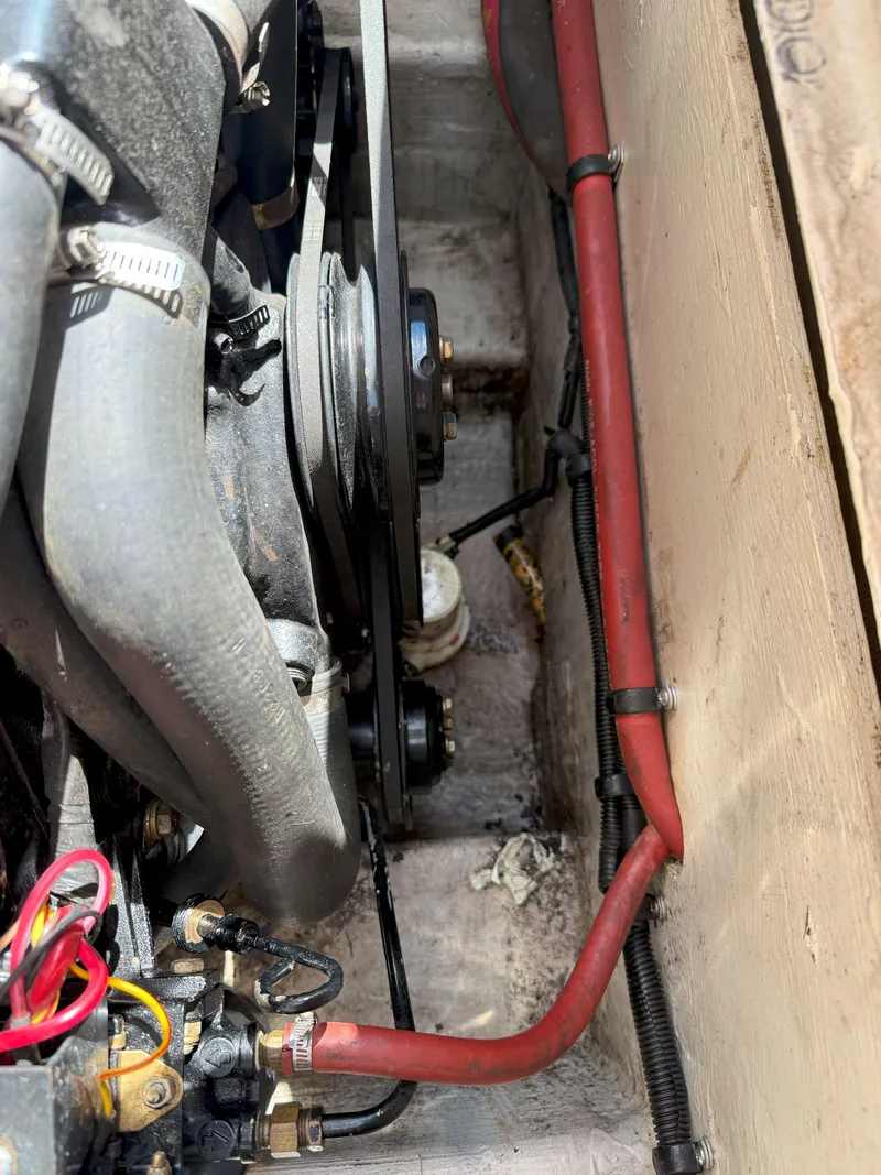 Slide: The Image of Engine compartment of a 1988 Slickcraft 268 SC boat, showing belts and hoses. - 44