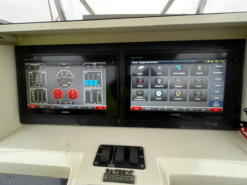 Slide: The Image of Dual Garmin displays on 2011 Fountain 38 CC Tournament Edition boat dashboard. - 17