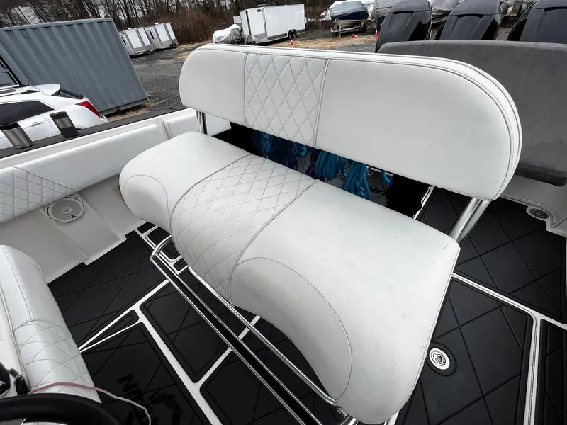 Slide: The Image of 2011 Fountain 38 CC Tournament Edition boat with white cushioned seating. - 23