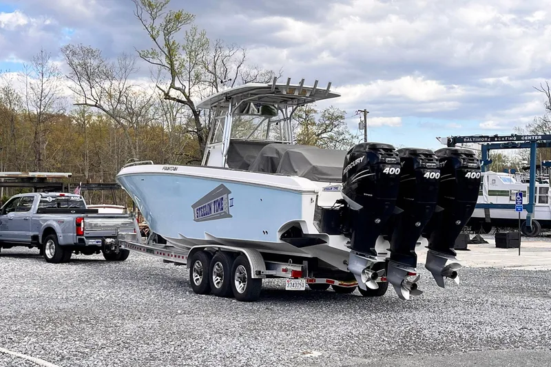 Slide: The Image of 2011 Fountain 38 CC Tournament Edition boat on trailer with triple 400 engines. - 39