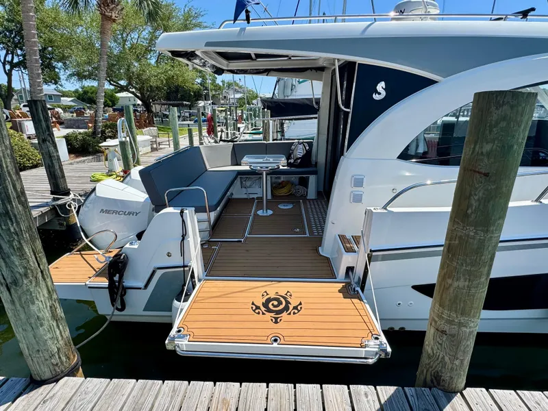 Slide: The Image of 2024 Beneteau Antares 11 docked, showcasing spacious deck and modern design. - 11