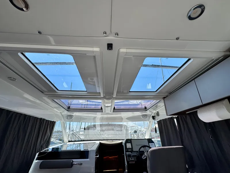 Slide: The Image of Interior view of 2024 Beneteau Antares 11 with skylights and modern cockpit design. - 16