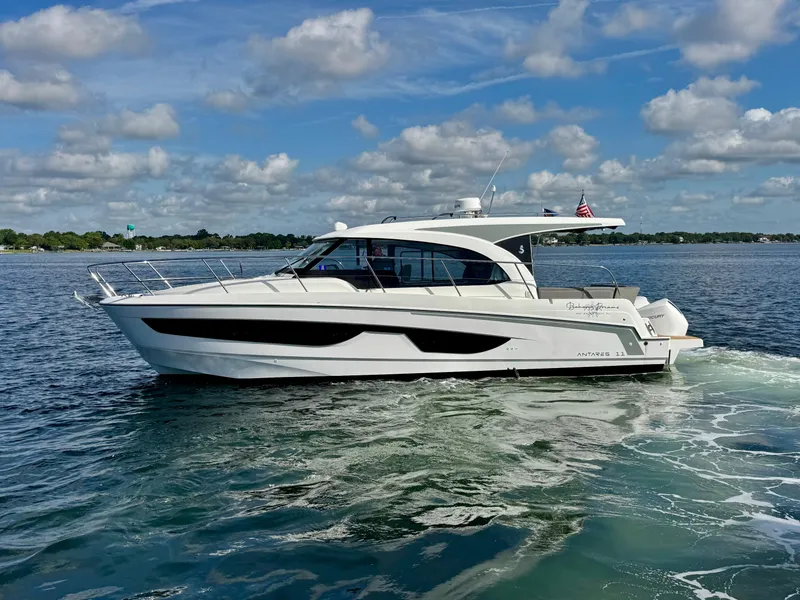 Slide: The Image of 2024 Beneteau Antares 11 cruising on a sunny day with a scenic backdrop. - 2