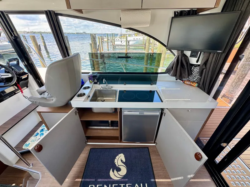 Slide: The Image of 2024 Beneteau Antares 11 interior kitchen with modern appliances and waterfront view. - 20