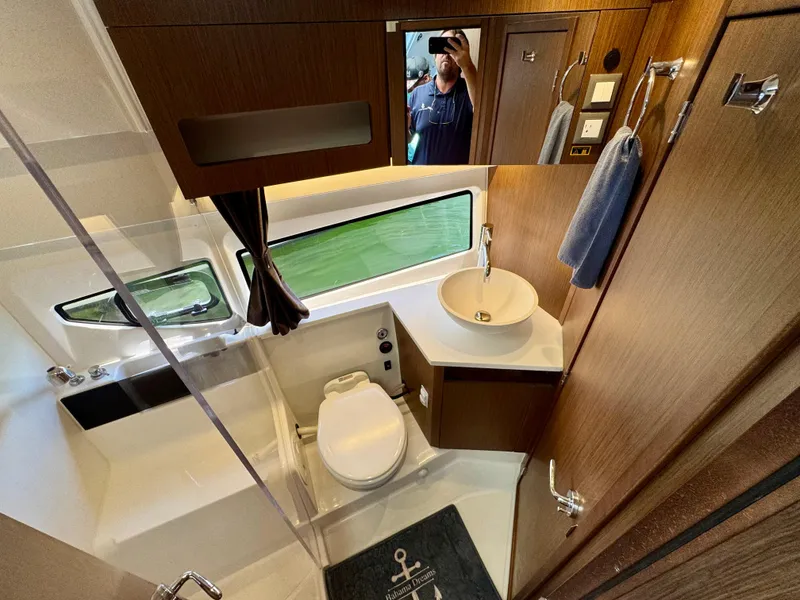 Slide: The Image of 2024 Beneteau Antares 11 bathroom with modern fixtures and wood accents. - 25