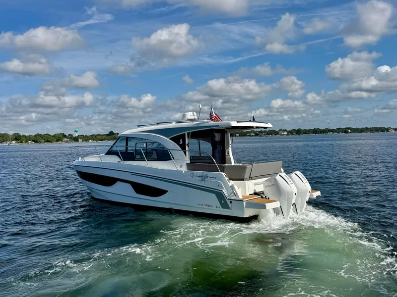 Slide: The Image of 2024 Beneteau Antares 11 cruising on a sunny day with a clear sky. - 7
