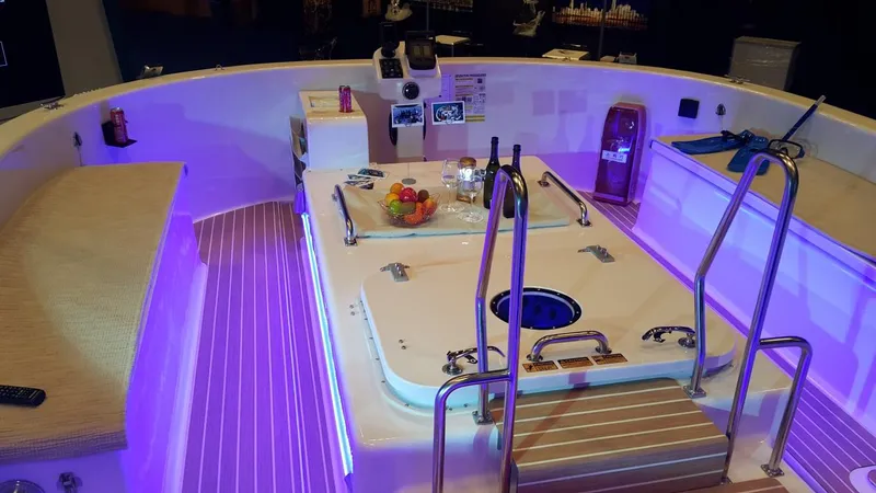 Slide: The Image of Interior of 2025 Penguin Semi-Submarine 2.1 Gasoline with purple lighting and fruit display. - 10