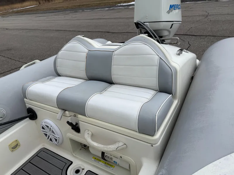 Slide: The Image of 2007 Zodiac Yachtline 380DL boat seat with gray and white upholstery. - 11