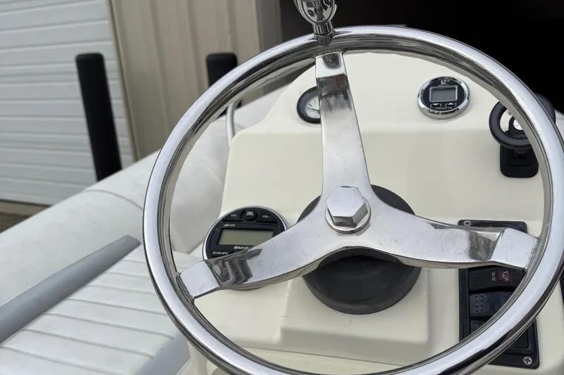 Slide: The Image of Steering wheel of a 2007 Zodiac Yachtline 380DL boat, featuring a sleek dashboard design. - 14