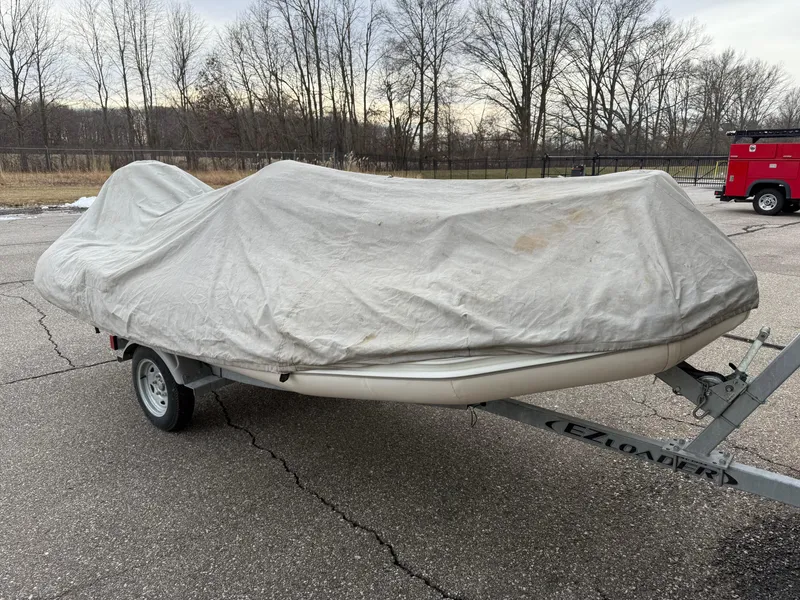 Slide: The Image of Covered 2007 Zodiac Yachtline 380DL on trailer in outdoor setting. - 6