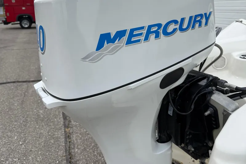 Slide: The Image of Mercury outboard motor on 2007 Zodiac Yachtline 380DL, parked on pavement. - 7