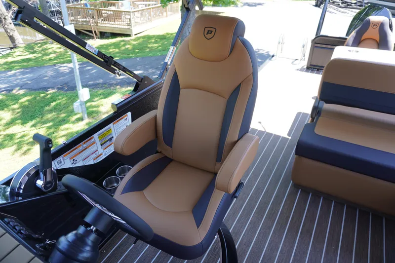 Slide: The Image of Captain's chair in 2025 Premier 250 Sunsation RS pontoon boat, featuring tan and black upholstery. - 15