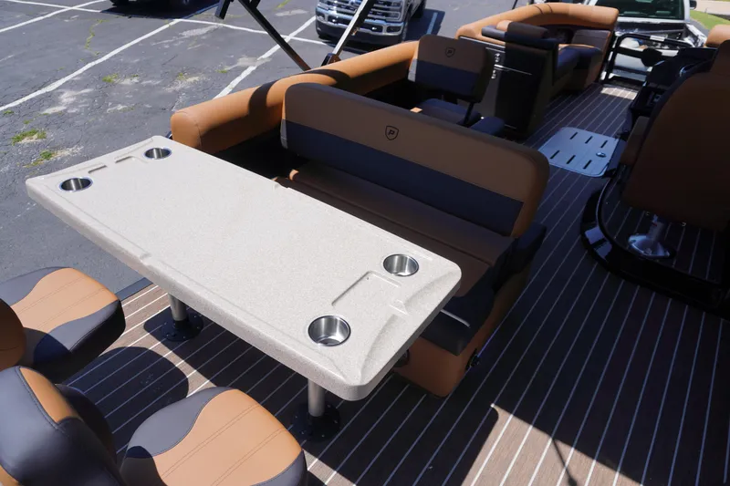 Slide: The Image of 2025 Premier 250 Sunsation RS boat interior with seating and table, featuring cup holders. - 17
