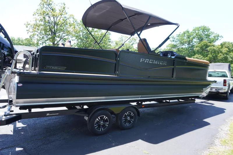 Slide: The Image of 2025 Premier 250 Sunsation RS pontoon boat on trailer, parked outdoors. - 2