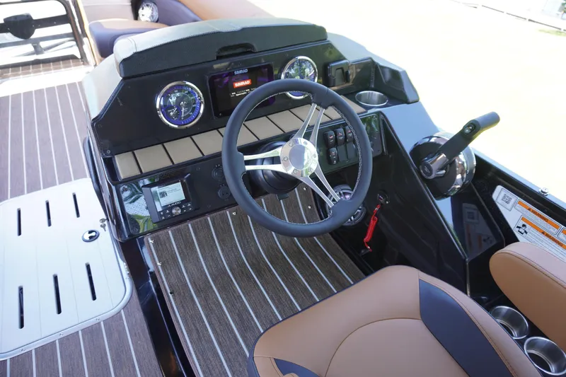 Slide: The Image of 2025 Premier 250 Sunsation RS boat dashboard with steering wheel and controls. - 5