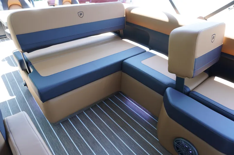 Slide: The Image of 2025 Premier 250 Sunsation RS boat interior with tan and navy seating, striped flooring. - 7