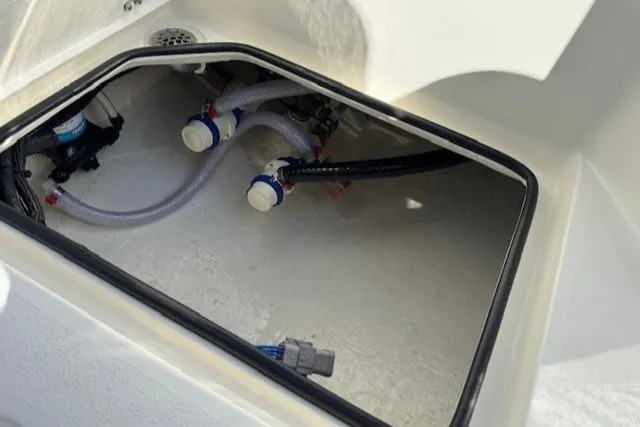 Slide: The Image of 2025 Pathfinder 2500 Hybrid boat compartment with visible plumbing and wiring. - 16