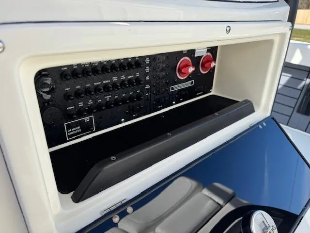 Slide: The Image of Control panel of 2025 Pathfinder 2500 Hybrid boat with switches and dials. - 19