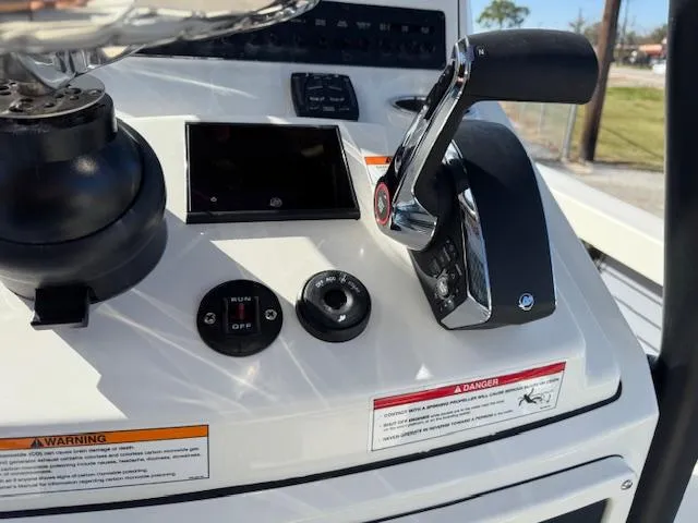 Slide: The Image of Control panel of 2025 Pathfinder 2500 Hybrid boat with throttle and switches. - 20