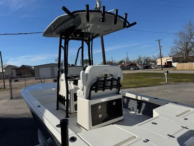 Slide: The Image of 2025 Pathfinder 2500 Hybrid boat with T-top and seating, parked outdoors. - 23