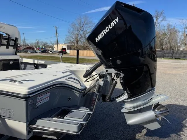 Slide: The Image of 2025 Pathfinder 2500 Hybrid boat with Mercury outboard motor, parked outdoors. - 24
