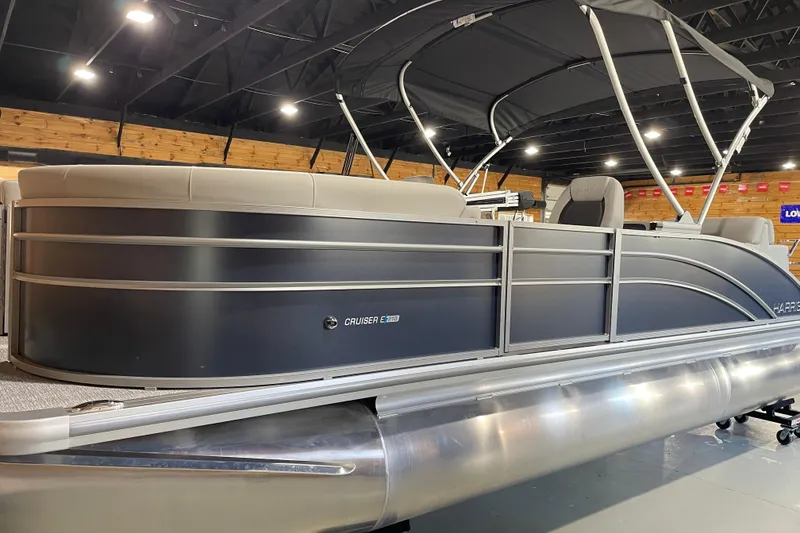 Slide: The Image of 2025 Harris Cruiser 210 pontoon boat with sleek design and spacious seating. - 0