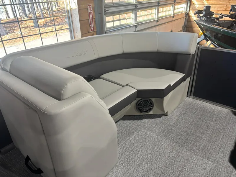 Slide: The Image of 2025 Harris Cruiser 210 interior with beige seating and speaker system. - 10
