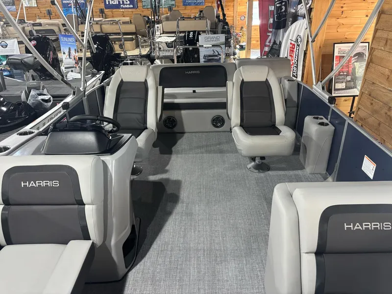 Slide: The Image of 2025 Harris Cruiser 210 pontoon boat interior with gray seating and steering console. - 11