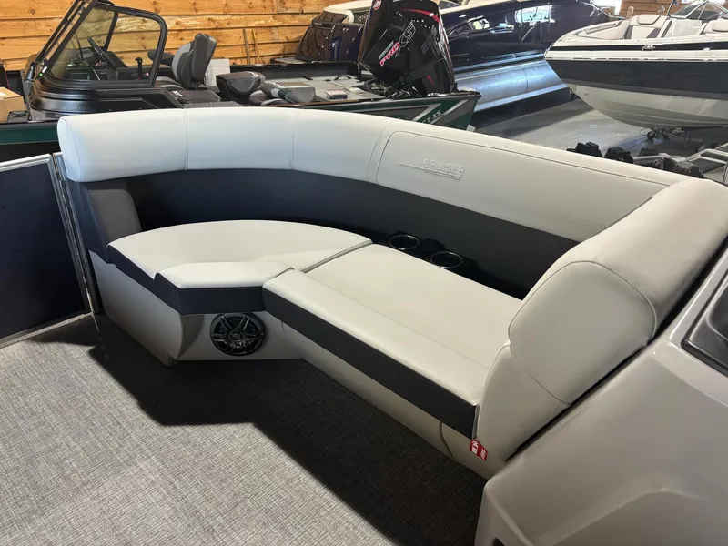 Slide: The Image of 2025 Harris Cruiser 210 boat interior with gray seating and cup holders. - 13