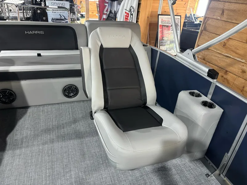 Slide: The Image of 2025 Harris Cruiser 210 interior with gray seating and cup holders. - 15