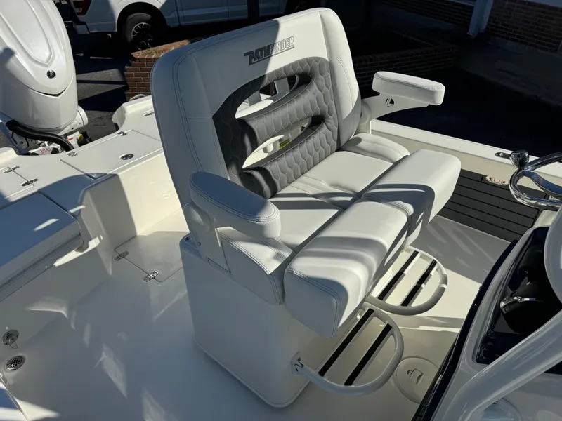 Slide: The Image of 2025 Pathfinder 2500 Hybrid boat seat with cushioned armrests and footrests in sunlight. - 10