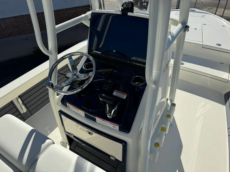 Slide: The Image of 2025 Pathfinder 2500 Hybrid boat console with steering wheel and controls. - 11