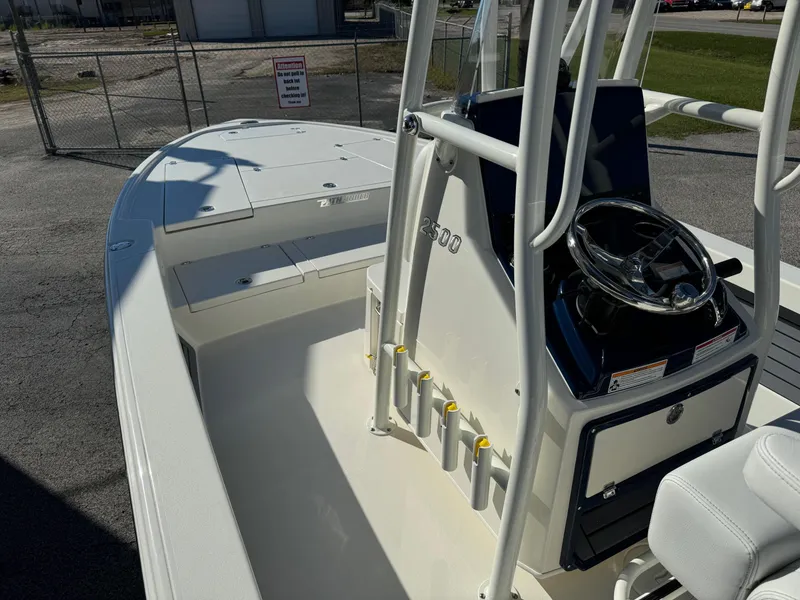 Slide: The Image of 2025 Pathfinder 2500 Hybrid boat interior with steering console and rod holders. - 14