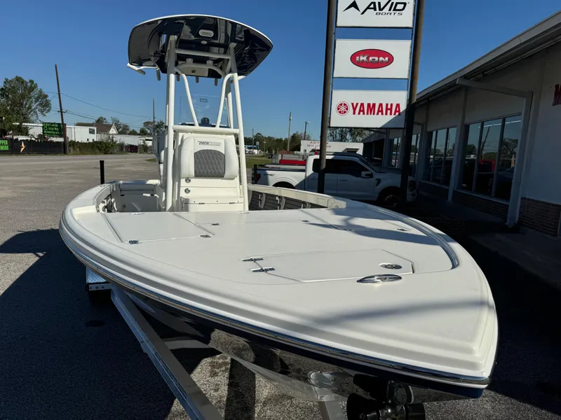 Slide: The Image of 2025 Pathfinder 2500 Hybrid boat displayed outdoors near dealership signs. - 6