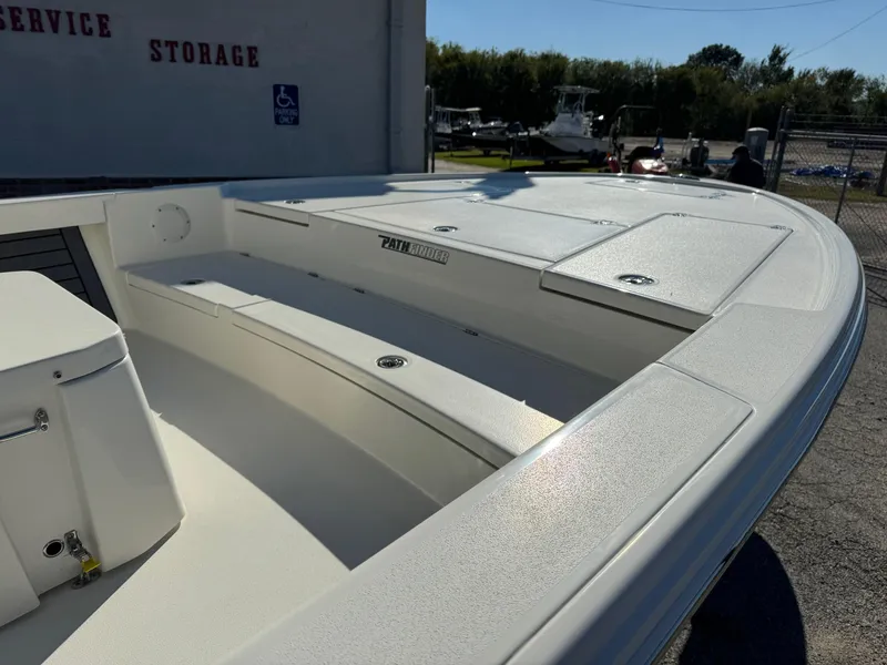 Slide: The Image of 2025 Pathfinder 2500 Hybrid boat, white deck, storage compartments, outdoor setting. - 8
