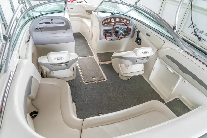 Slide: The Image of 2006 Chaparral 220 SSi boat interior with beige seating and dashboard controls. - 10