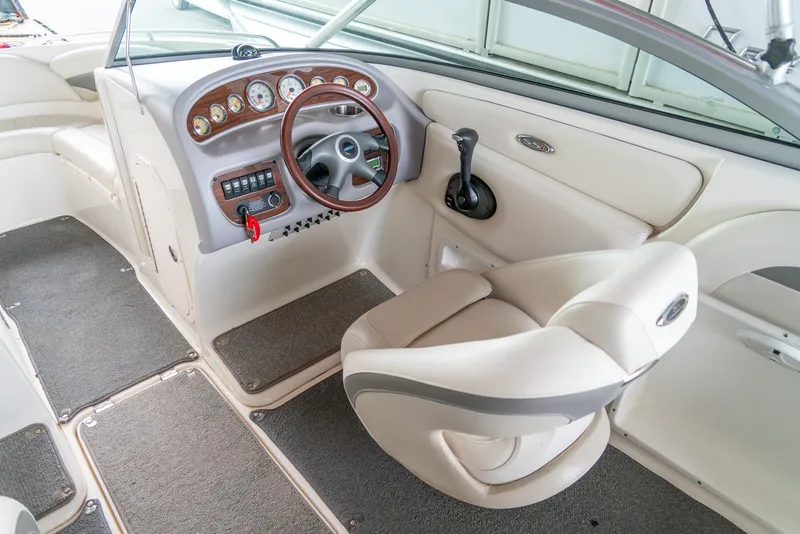 Slide: The Image of 2006 Chaparral 220 SSi boat interior with steering wheel and dashboard controls. - 11