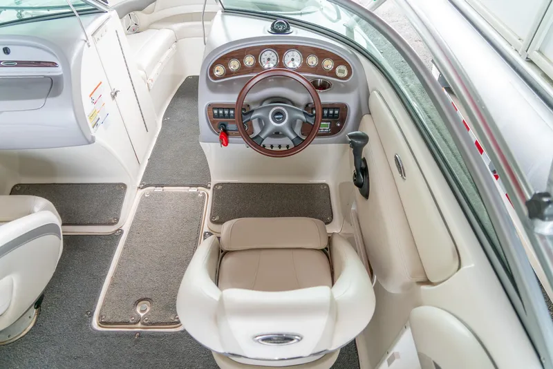 Slide: The Image of 2006 Chaparral 220 SSi boat interior with steering wheel and dashboard controls. - 12